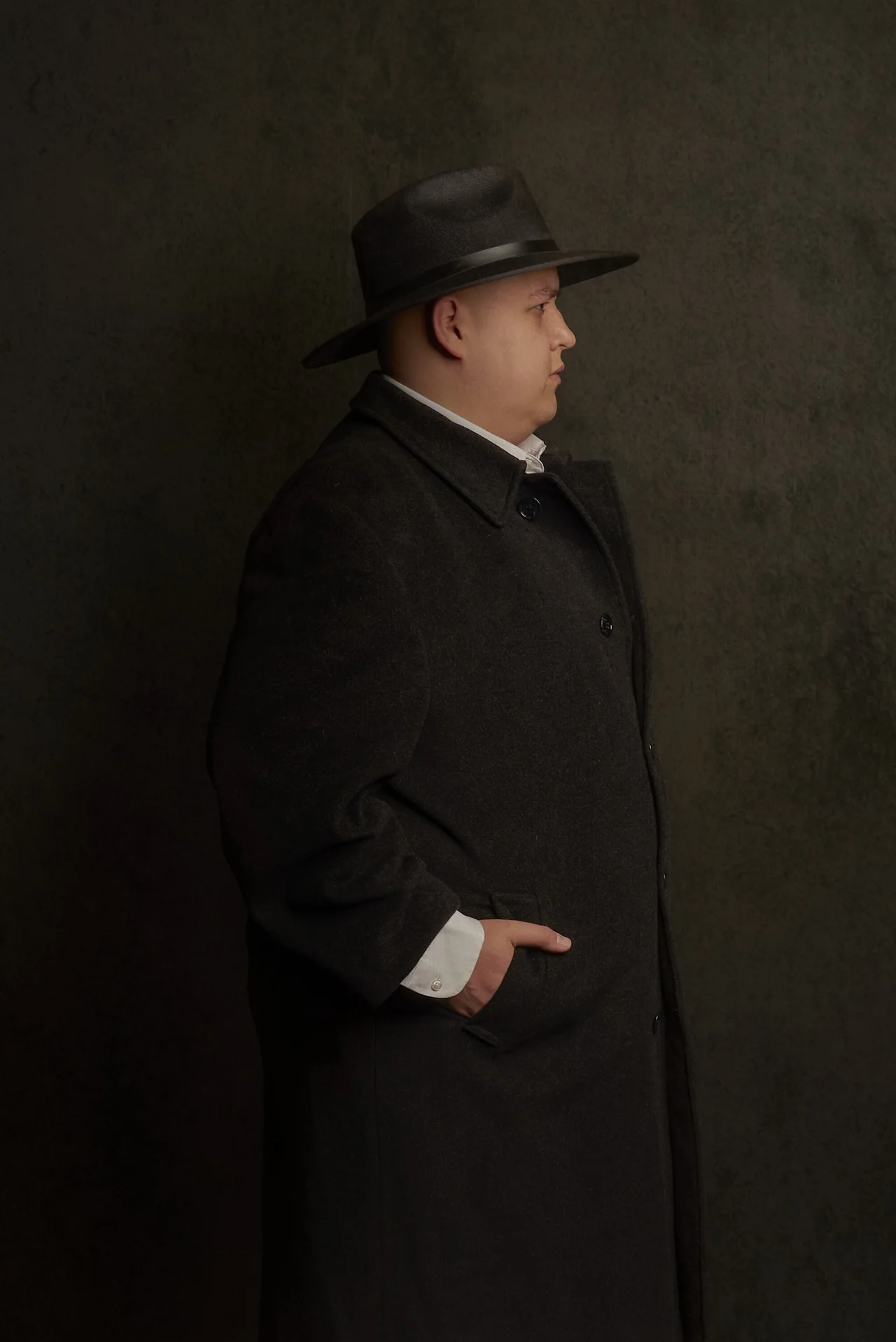 Raúl Alcocer in a dark coat and hat